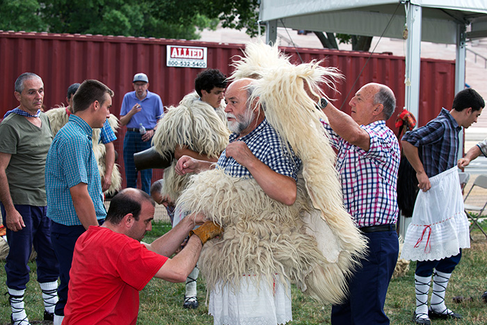 With their loud bells and rainbow-ribboned cone hats, the Joaldunak procession is quite a spectacle, but their process of getting dressed is quite an event as well. It takes a team to transform into sheep. Photo by Walter Larrimore, Ralph Rinzler Folklife Archives