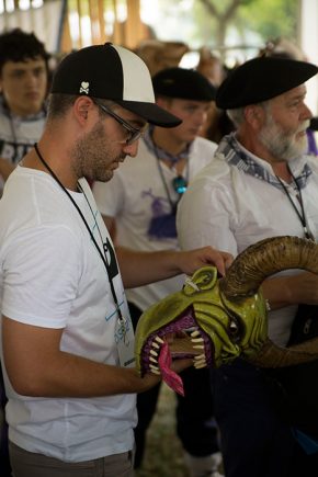 The Basque Joaldunak and the California Grupo Nuu Yuku, both traditional parade groups, met for this first time this morning to discuss potential collaboration. The Joaldunak presenter, Unai Bereau, examined one of the diablos masks. Photo by Pruitt Allen, Ralph Rinzler Folklife Archives