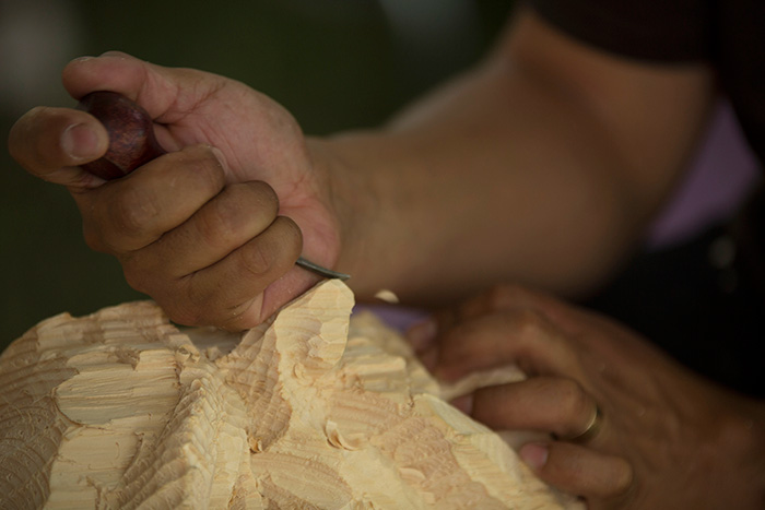 Alexis Vásquez has been demonstrating his mask making skills in The Studio, chiseling away at large blocks of wood. Slowly faces emerge. Photo by Pruitt Allen, Ralph Rinzler Folklife Archives