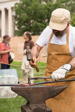 César Alcoz demonstrates his craft of <em>burdinola</em>, or iron working, by heating iron rods in a forge and molding them on an anvil. Photo by Pruitt Allen, Ralph Rinzler Folklife Archives