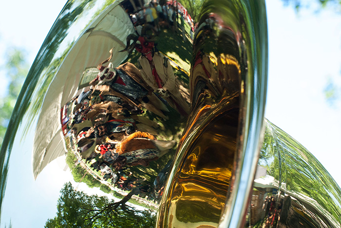 Grupo Nuu Yuku poses in the bell of Pedro Flores's sousaphone before their performance with Banda Brillo de San Miguel Cuevas at the Sounds of California Stage & Plaza. Photo by Ronald Villasante, Ralph Rinzler Folklife Archives