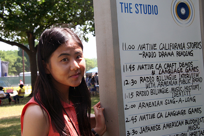 Ying Diao is a <em>Sounds of California</em> intern, helping facilitate The Studio tent. Photo by Elisa Hough