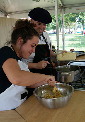 Rakel Rey alternates mixing hot water and corn flour to make talo dough. Photo by Joe Furgal, Ralph Rinzler Folklife Archives