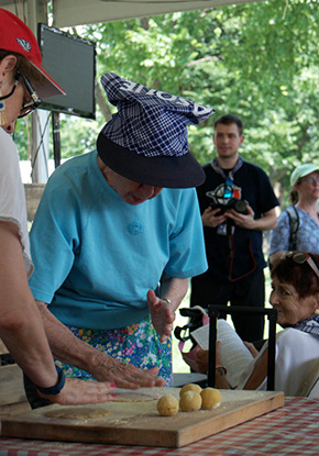 Visitors try their hands at flattening talo dough. Photo Joe Furgal, Ralph Rinzler Folklife Archives