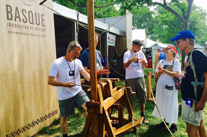 Visitors step in closer to discuss the specifics and technical details of boat building with craftsmen from Albaola. Photo by Robin Morey