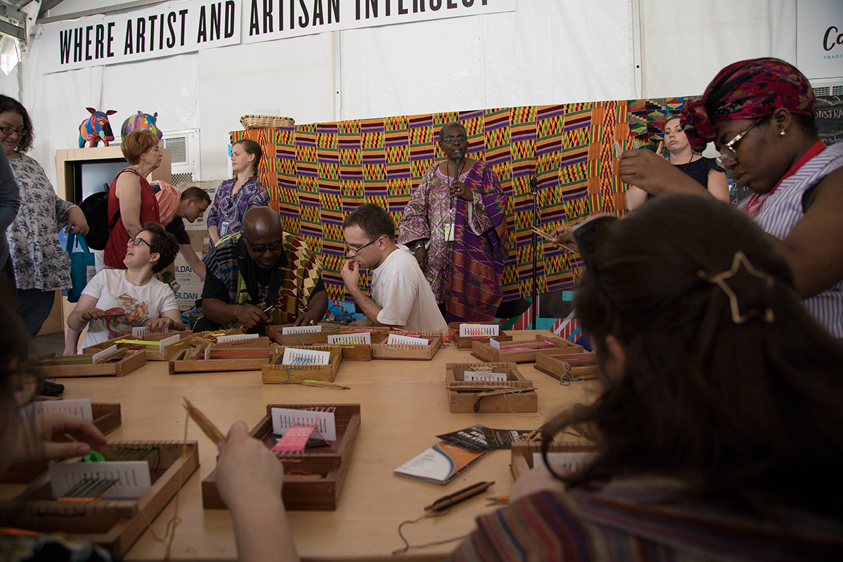Kwasi Asare leads a kente cloth weaving workshop in the Festival Marketplace