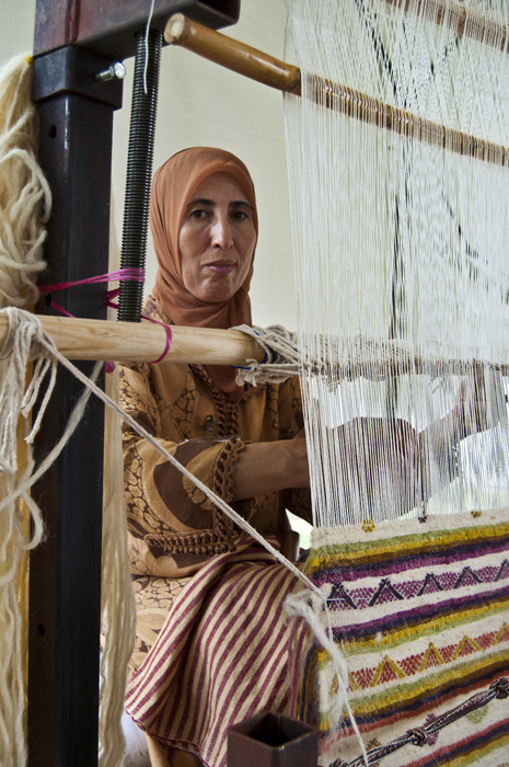 Moroccan weaver Fatima Akachmar works at her loom.