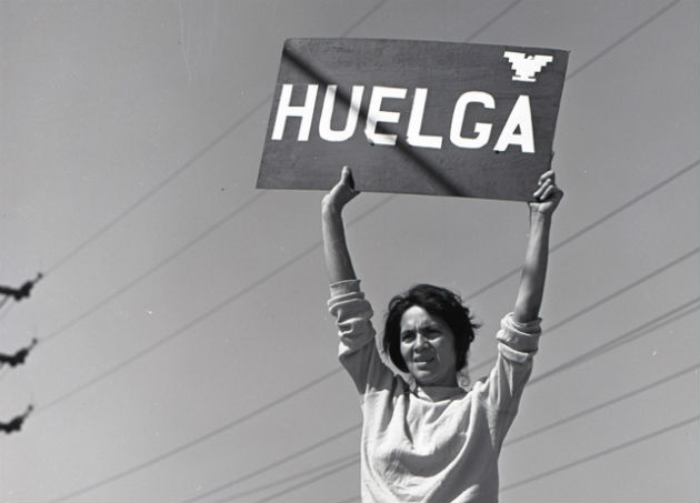 Dolores Huerta holds up a sign indicating “strike” during the early days of the grape boycott, Delano, CA, 1965. This is among the materials on display in the One Life: Dolores Huerta exhibition at the National Portrait Gallery. Photo courtesy of Harvey Richards Media Archive, ©Paul Richards