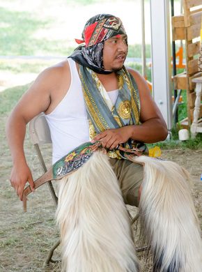 Raymundo Guzman getting dressed for a Grupo Nuu Yuku performance. Photo by Josh Weilepp, Ralph Rinzler Folklife Archives